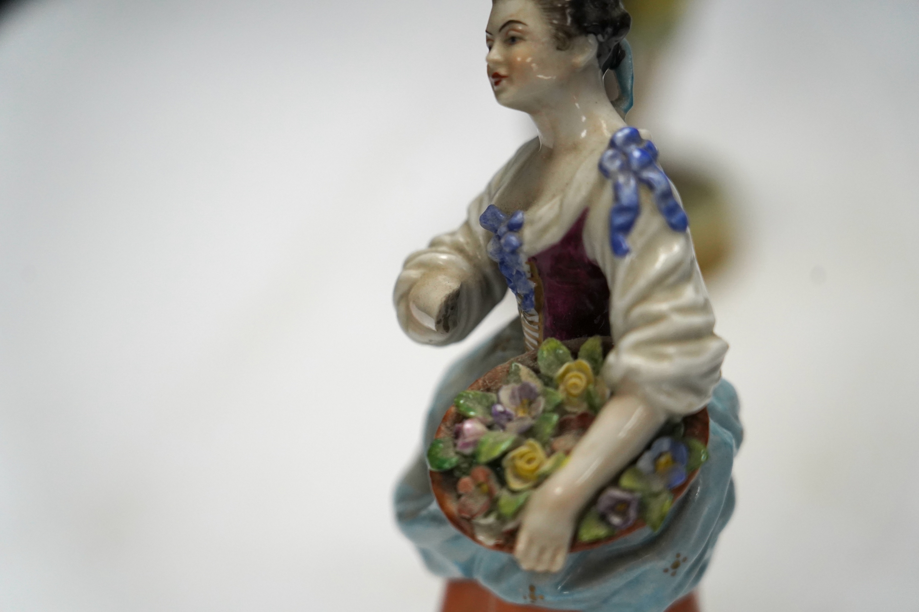 Three late 19th century porcelain putti spill vases and four smaller figurines, tallest 23cm high